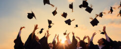 Photo of College Students Throwing their Cap in the Air with Joy