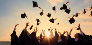 Photo of College Students Throwing their Cap in the Air with Joy