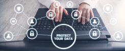 Photo of hands on a keyboard with icons floating in the air representing locks and humans with a central message - Protect Your Data.