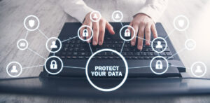 Photo of hands on a keyboard with icons floating in the air representing locks and humans with a central message - Protect Your Data.